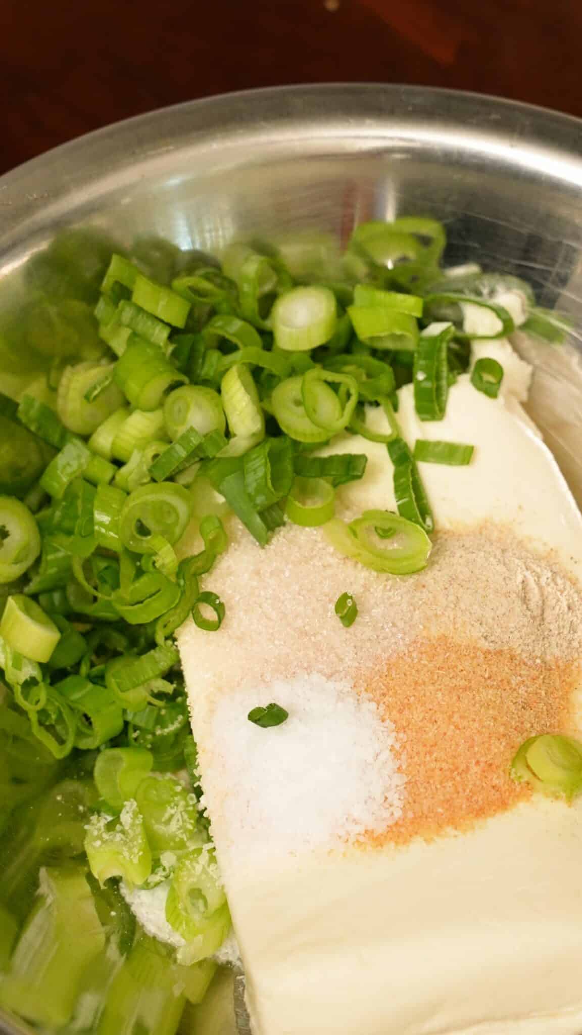 Ingredients for the crab rangoon filling in a metal bowl.