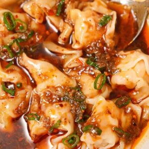 Din Tai Fung wontons in spicy sauce in a bowl.