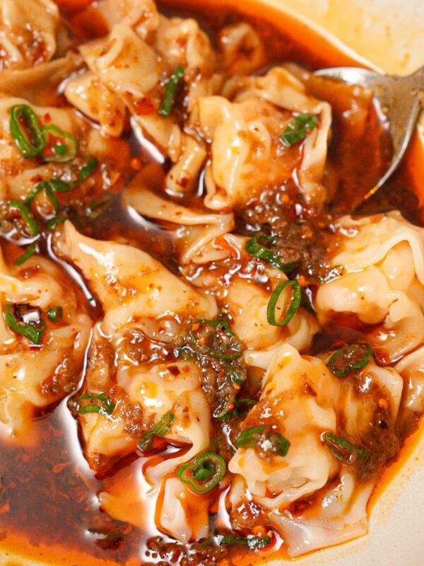 Din Tai Fung wontons in spicy sauce in a bowl.