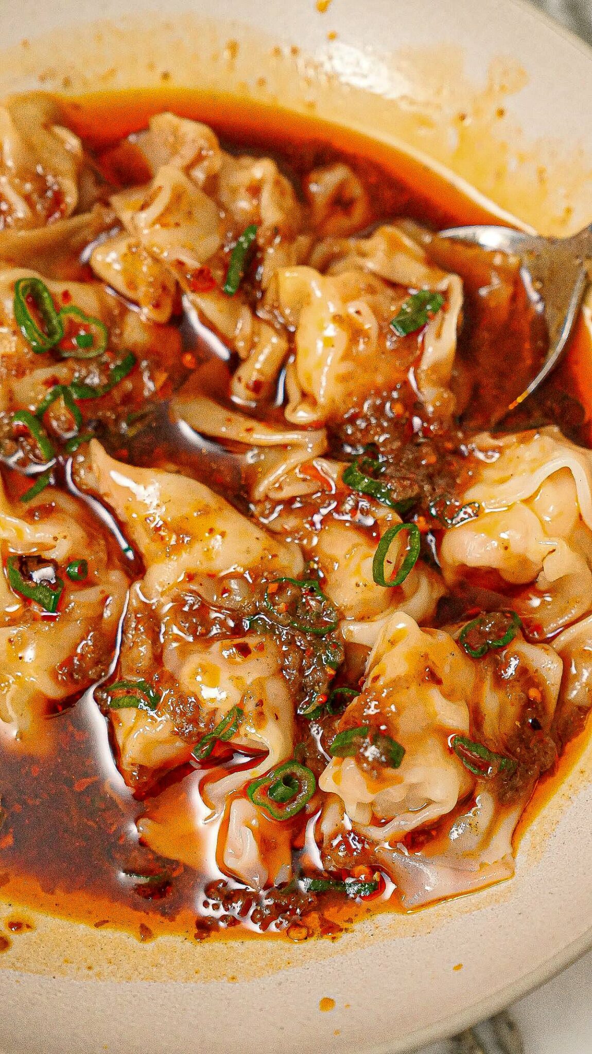 Din Tai Fung Spicy Wonton Sauce in a bowl with wontons.