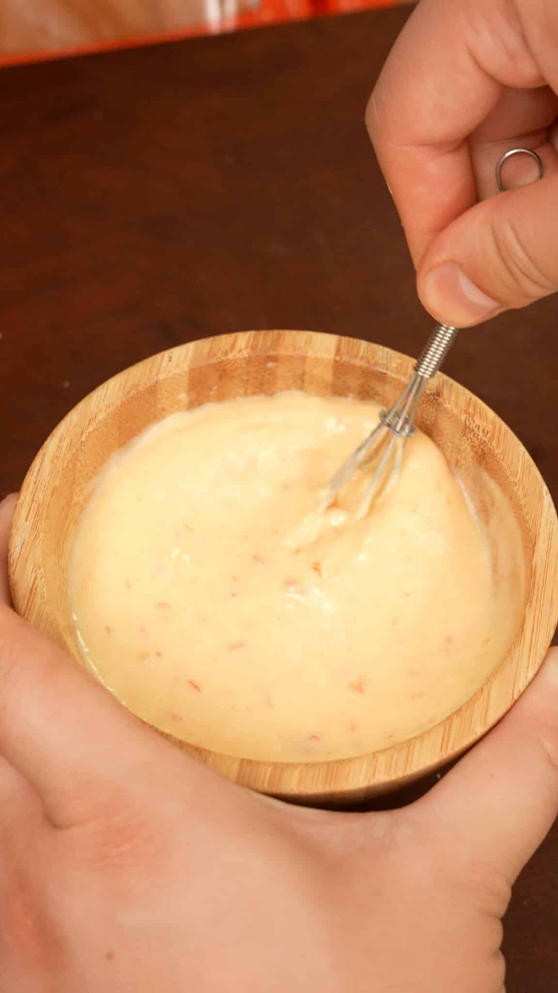 Sweet thai chili mayo mixed in a bowl for fried shrimp sliders.