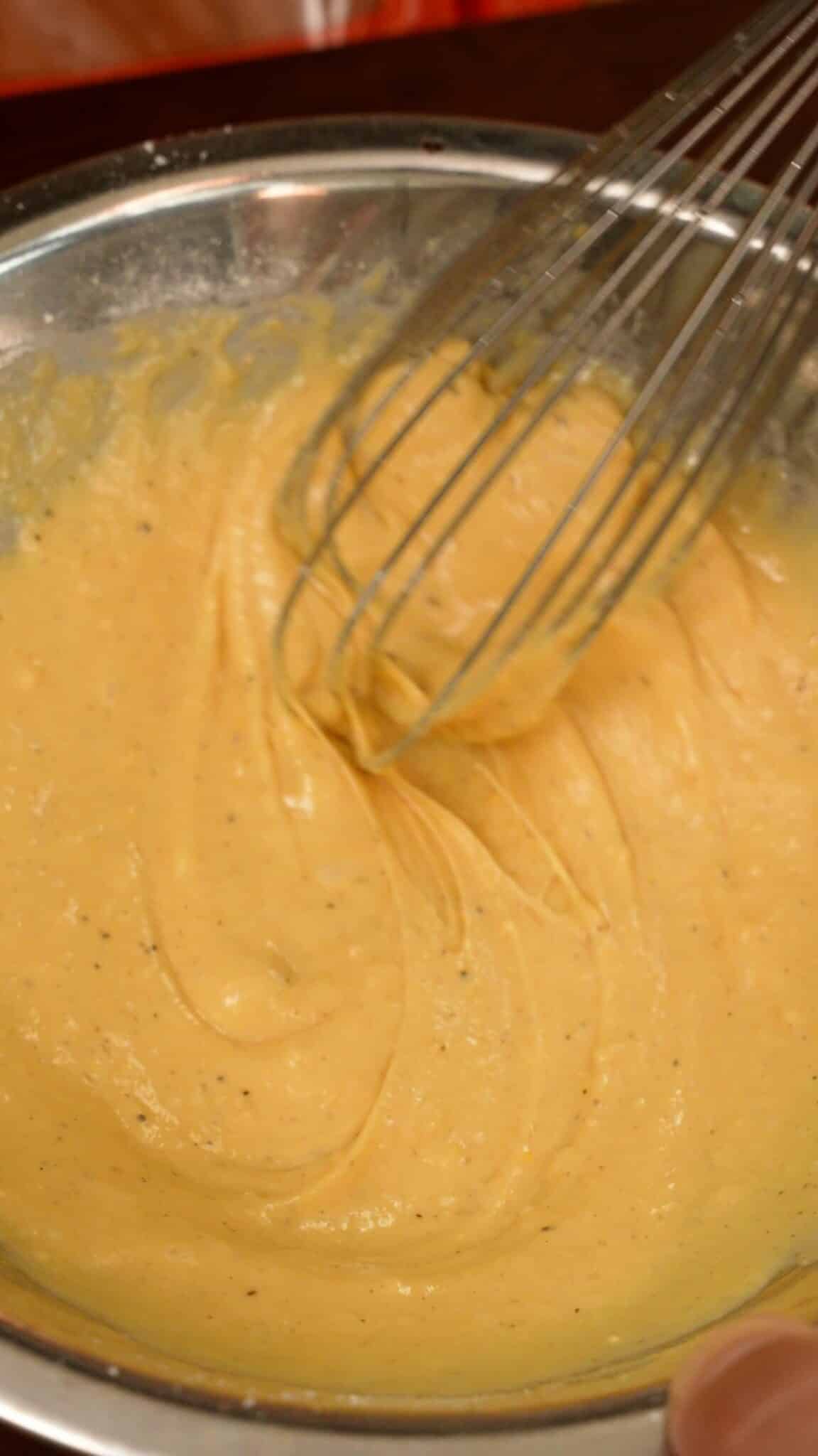 Wet batter for fried shrimp sliders mixed in a bowl.