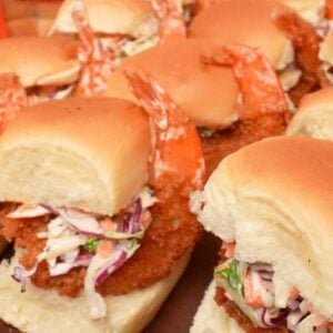 Fried shrimp sliders on a cutting board.