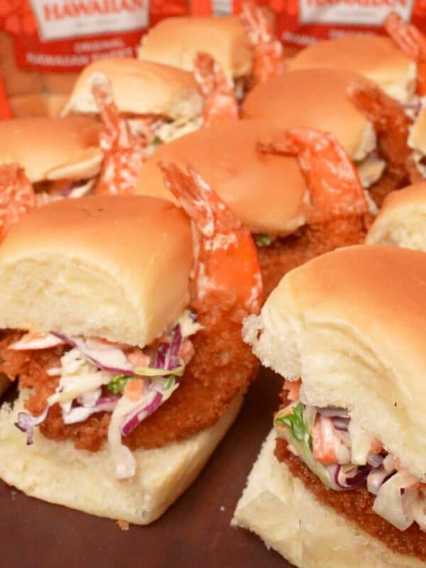 Fried shrimp sliders on a cutting board.