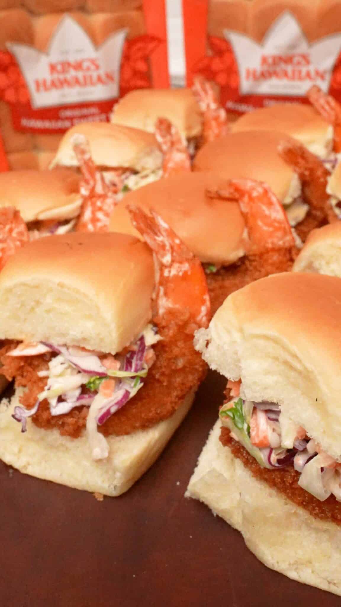 Fried shrimp sliders on a cutting board.