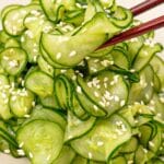 Japanese cucumber salad (Sunomono) in a bowl with a pair of chopsticks.