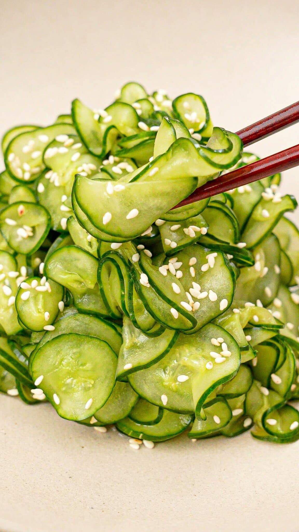 Japanese cucumber salad (Sunomono) in a bowl with a pair of chopsticks.