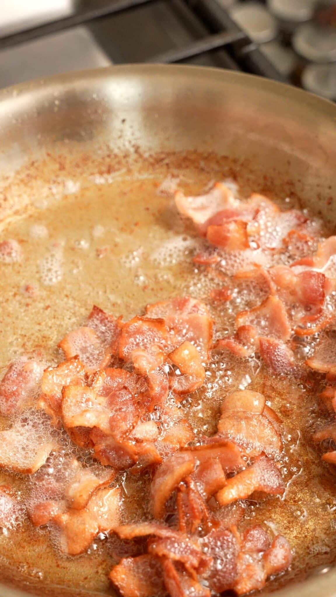 Bacon cooking in a pan.