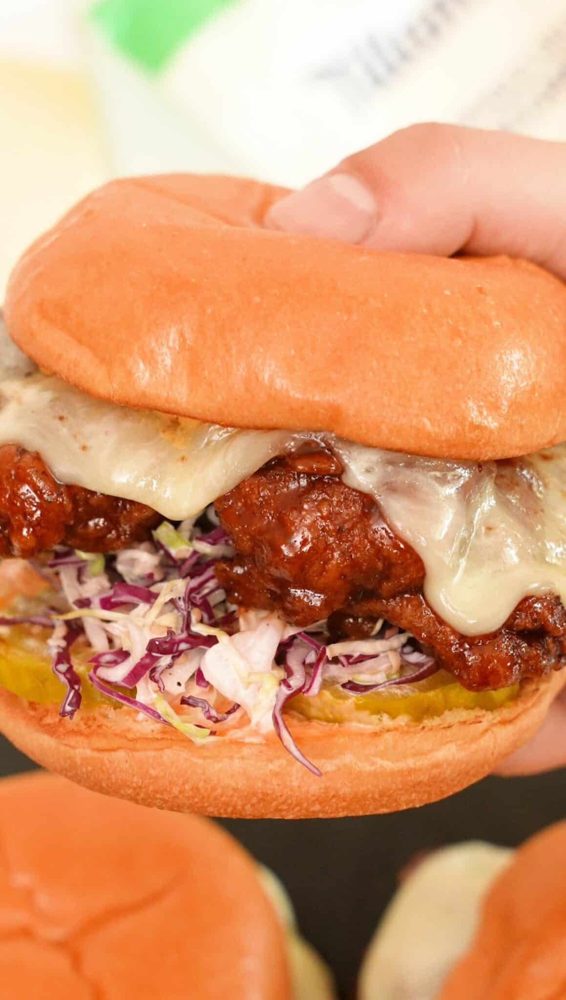 Korean Fried Chicken Sandwich held in hands.