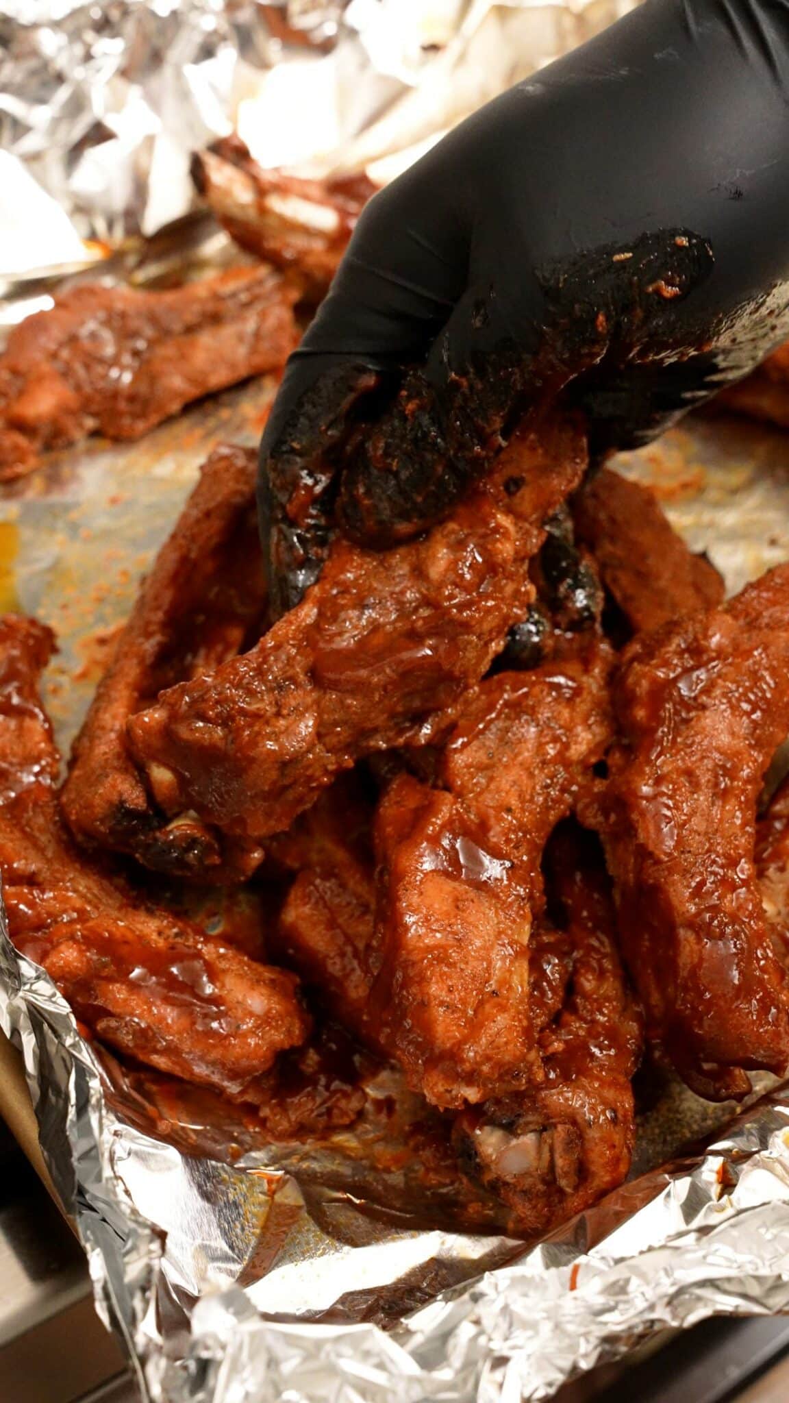 Mixing the oven baked ribs with bbq sauce.