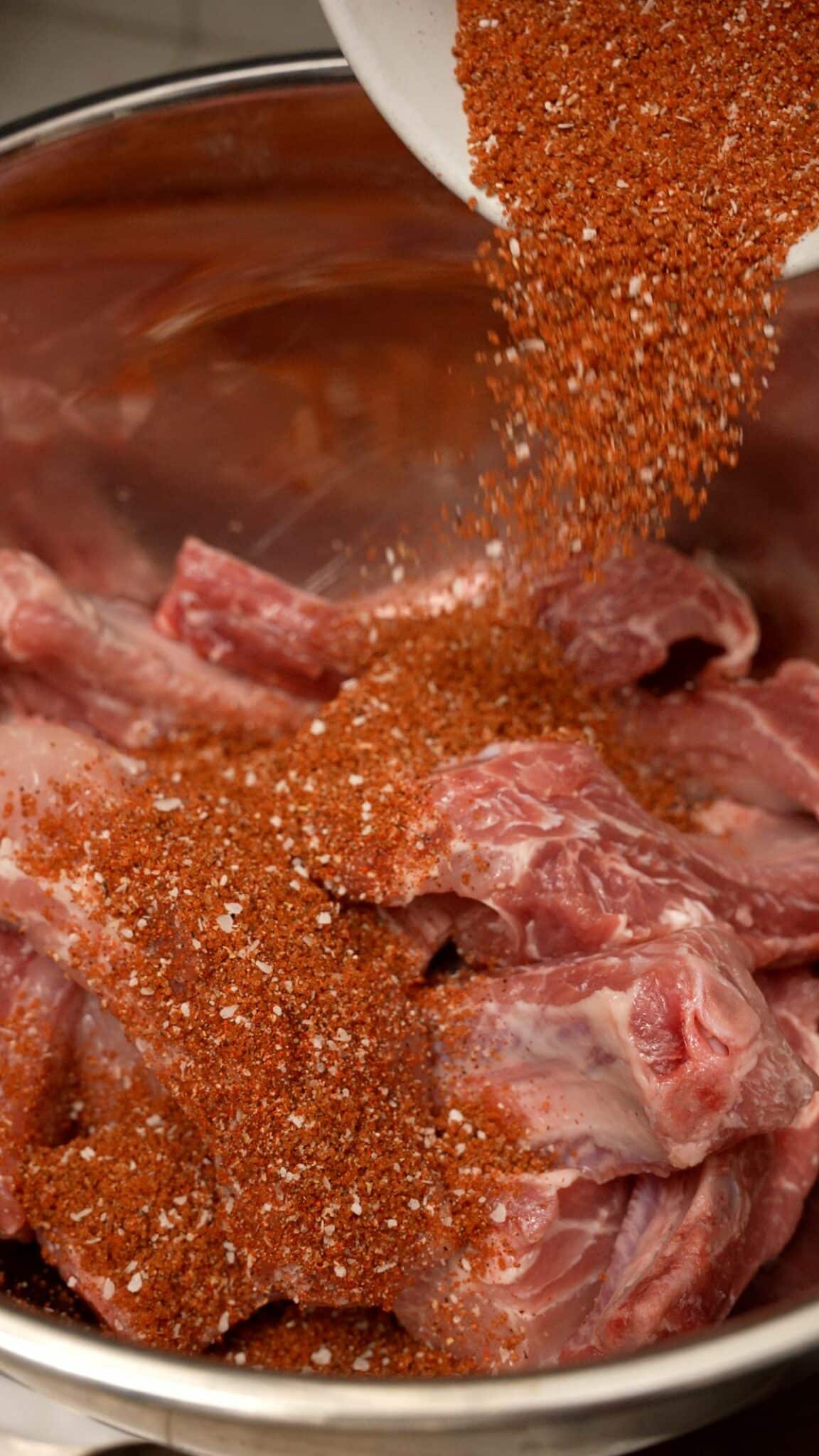 Seasoning blend being added to the ribs.