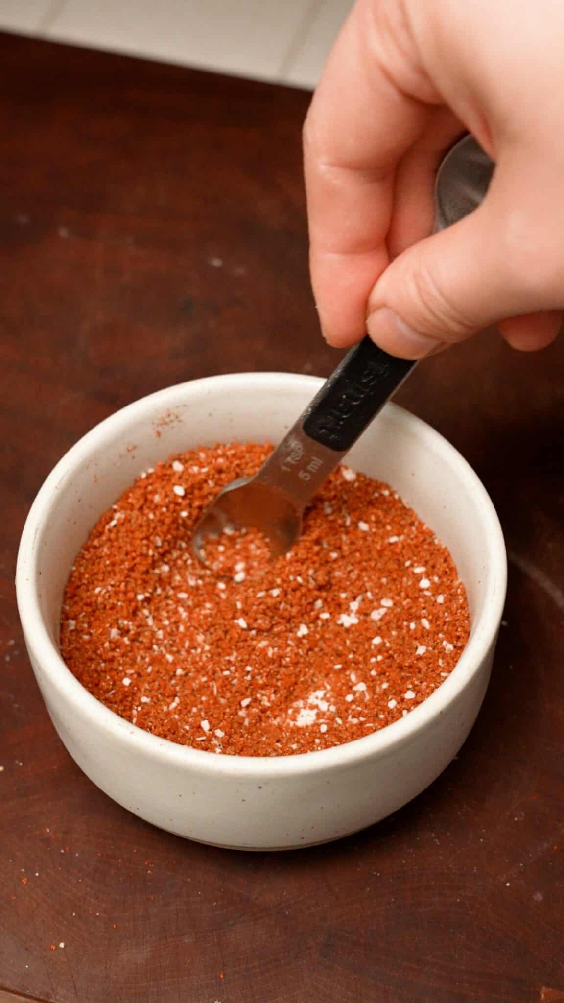 Mixing spice blend in a bowl.