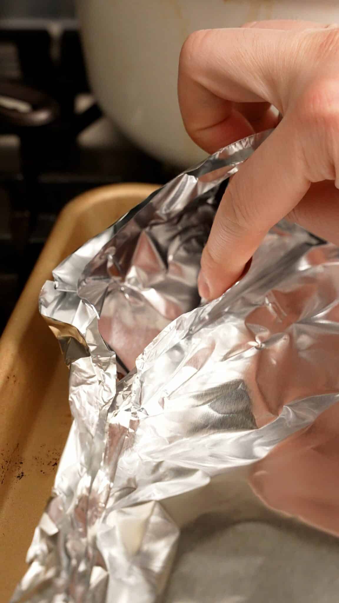 Showing a corner vent in the foil before baking the ribs.