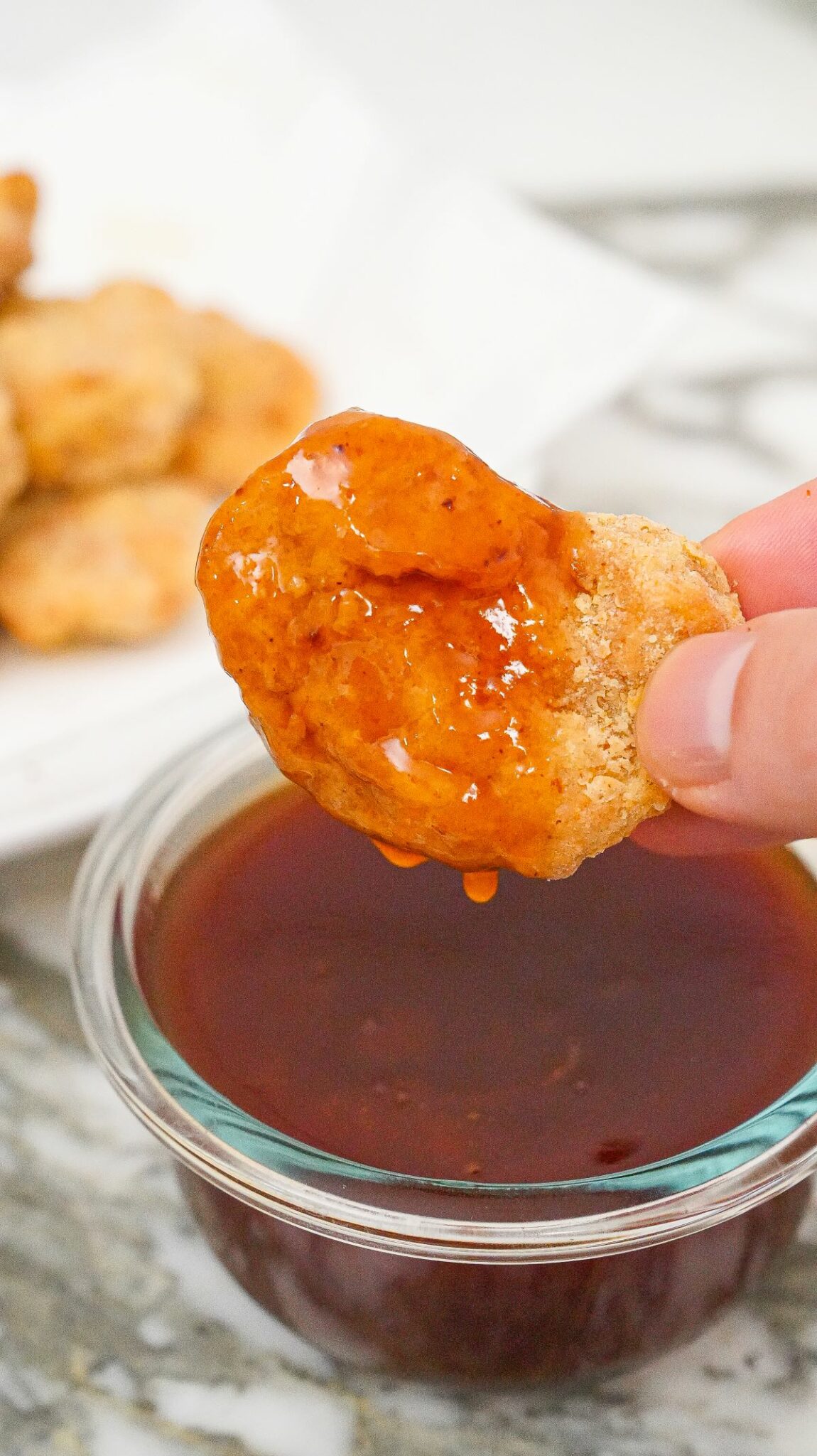 Sweet and sour sauce on a chicken nugget.