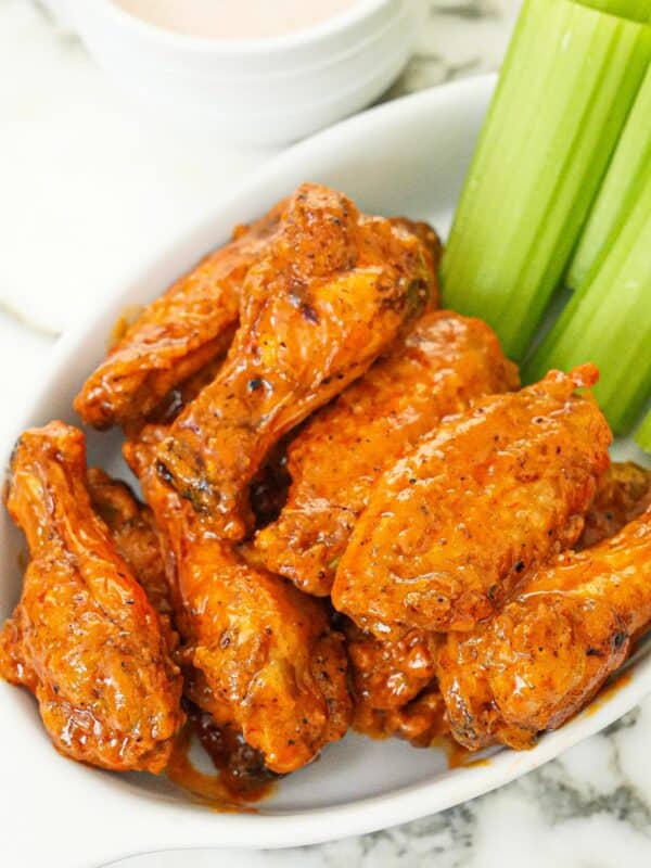 Air Fryer Buffalo Wings in a bowl with celery and ranch dressing.