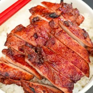 Char Siu Chicken over a plate of rice.
