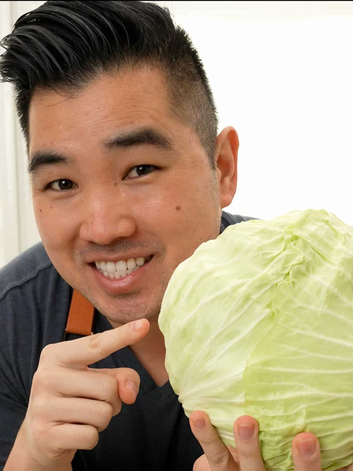 Chris Joe holding a head of Taiwanese cabbage.