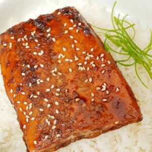 Honey Soy Glazed salmon over rice in a bowl.