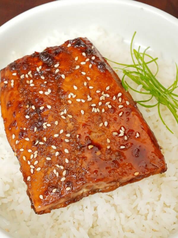 Honey Soy Glazed salmon over rice in a bowl.