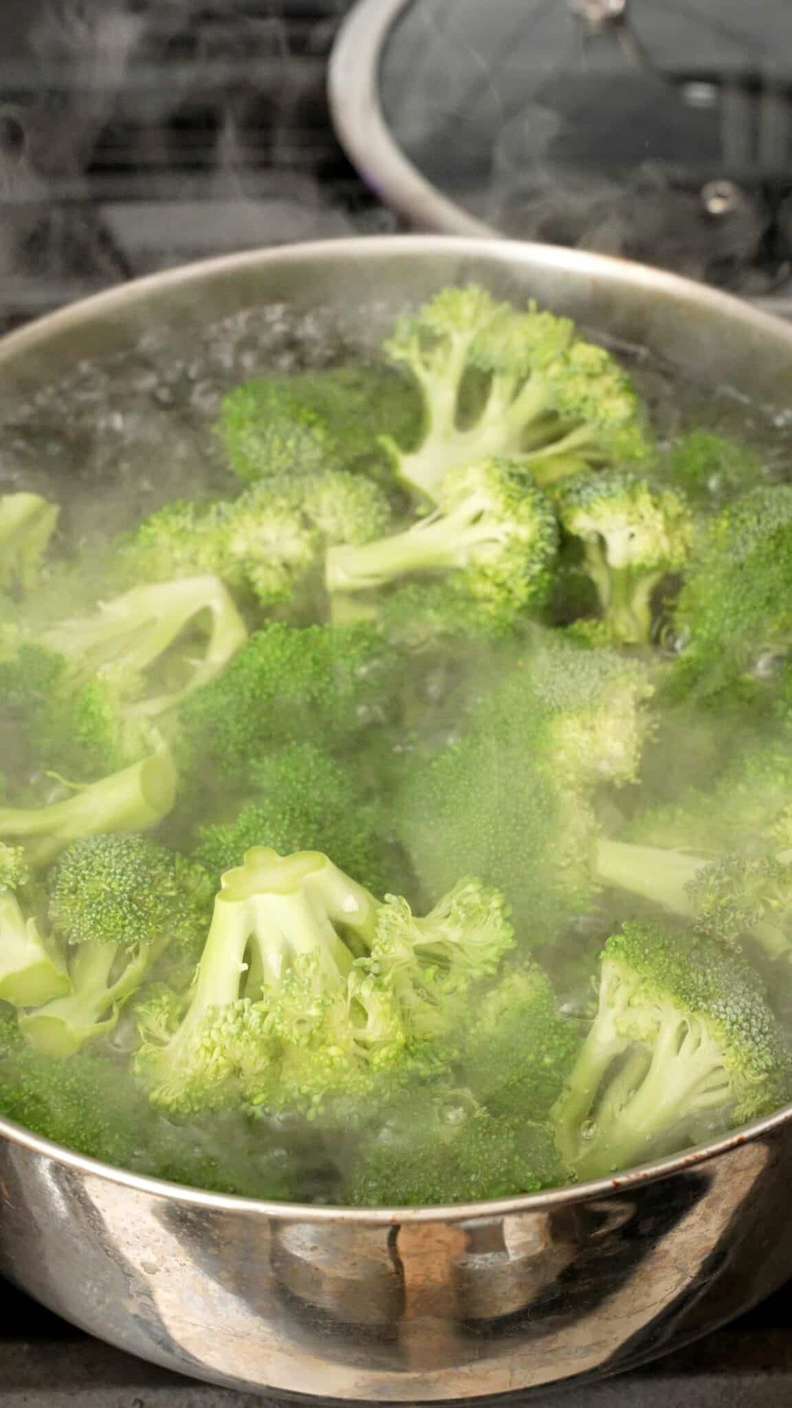 Broccoli being blanched in boiling salted water.
