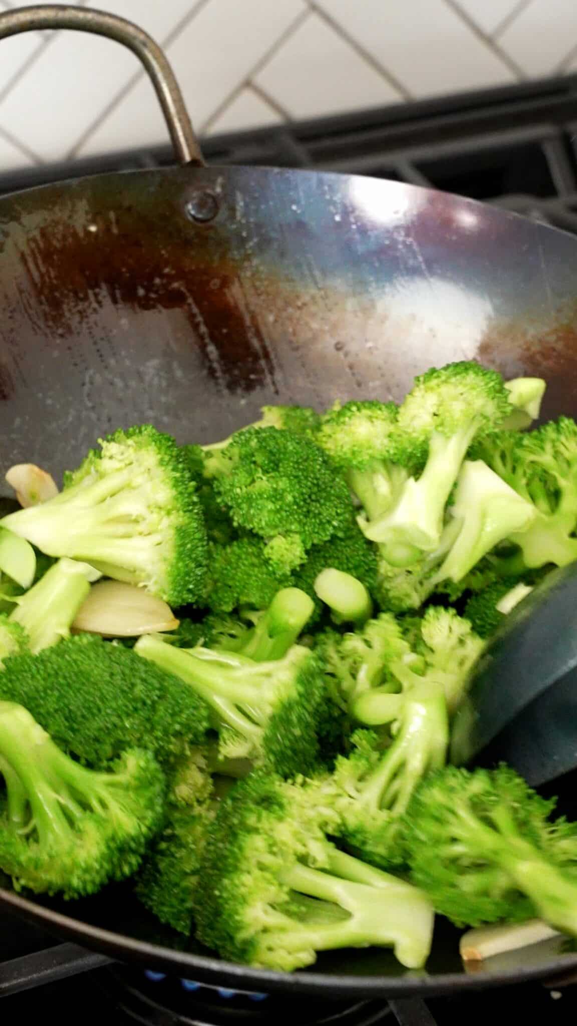 Broccoli with Garlic stir frying in a wok.