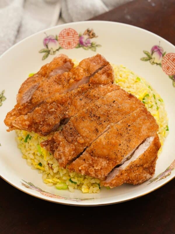 The Din Tai Fung Fried Pork Chop over the Din Tai Fung fried rice in a bowl.