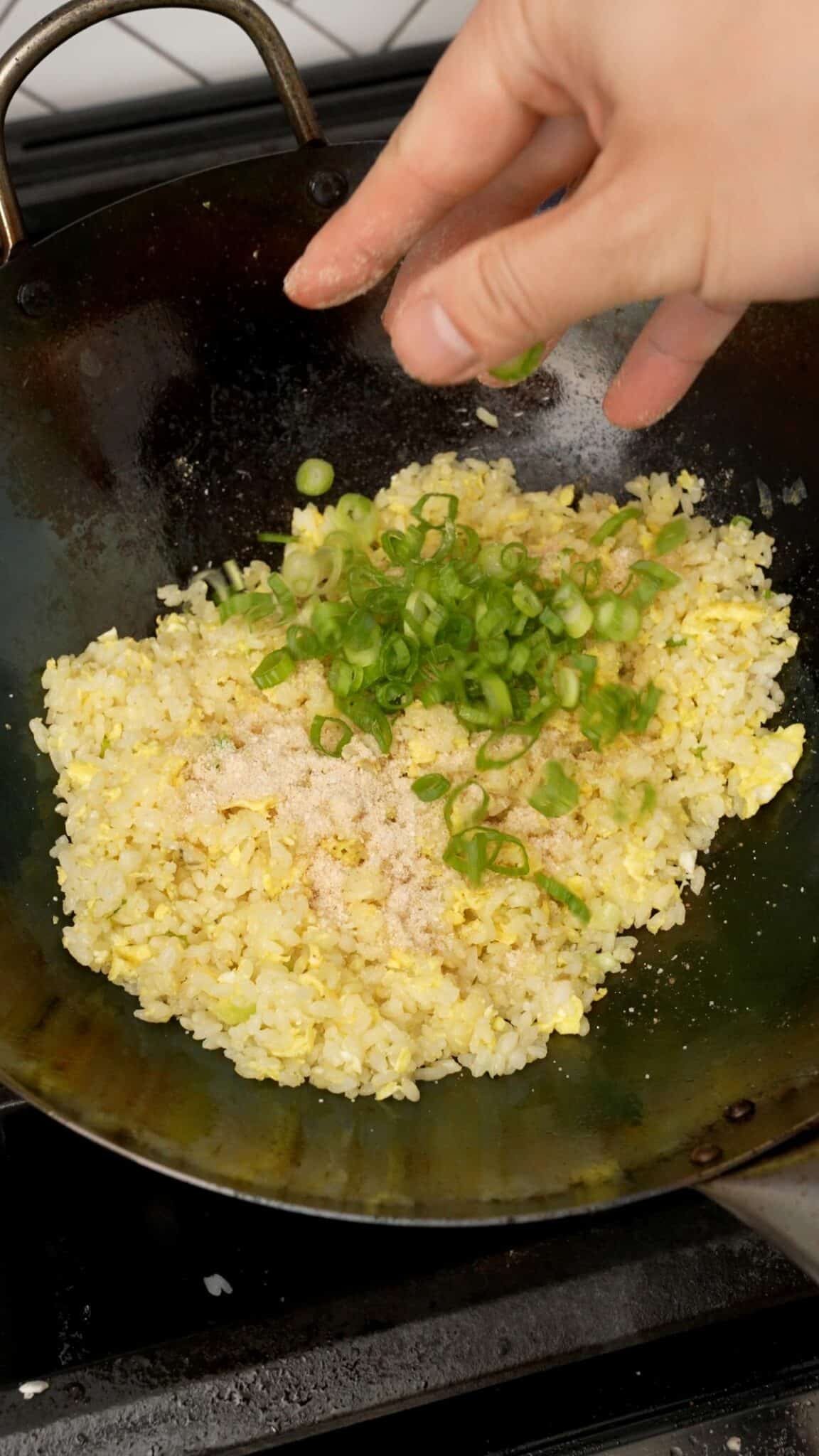Scallion greens, white pepper, sugar, chicken bouillon powder, and salt seasoning the rice.