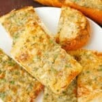 Pieces of baked garlic bread on a plate.