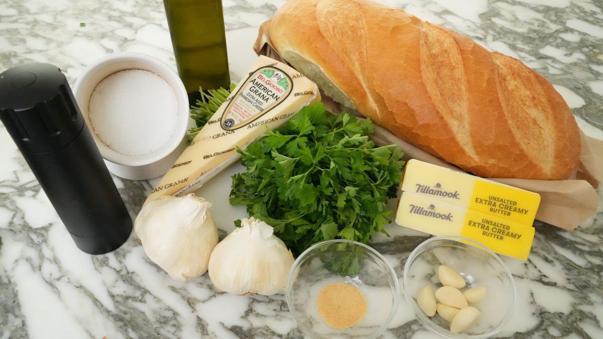 Raw ingredients for Garlic Bread on a table.