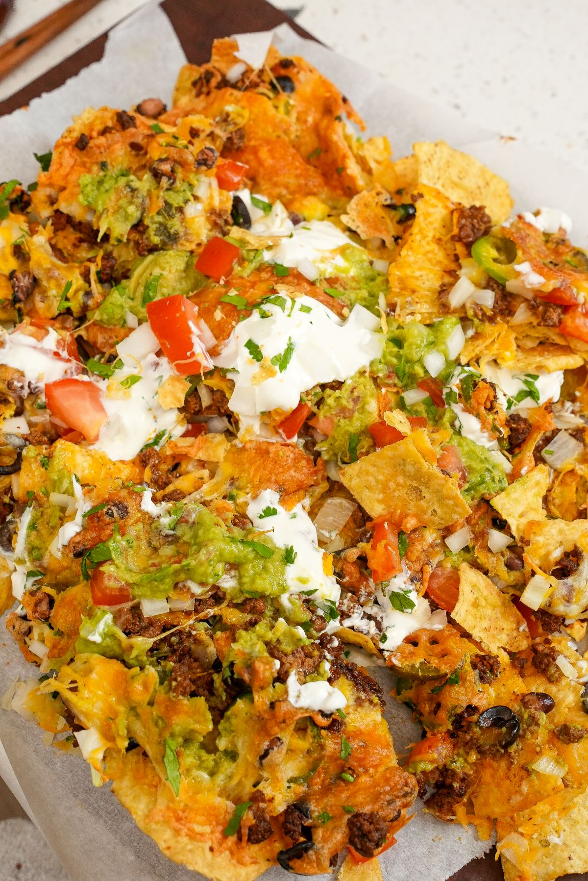Air Fryer Nachos on top of parchment paper.