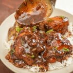 Chicken Adobo over rice in a bowl.