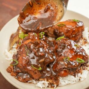 Chicken Adobo over rice in a bowl.