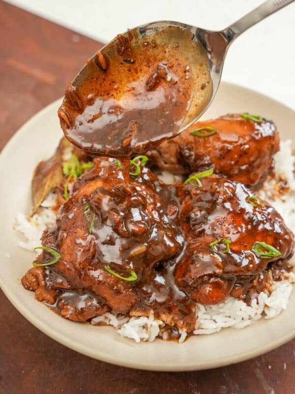 Chicken Adobo over rice in a bowl.
