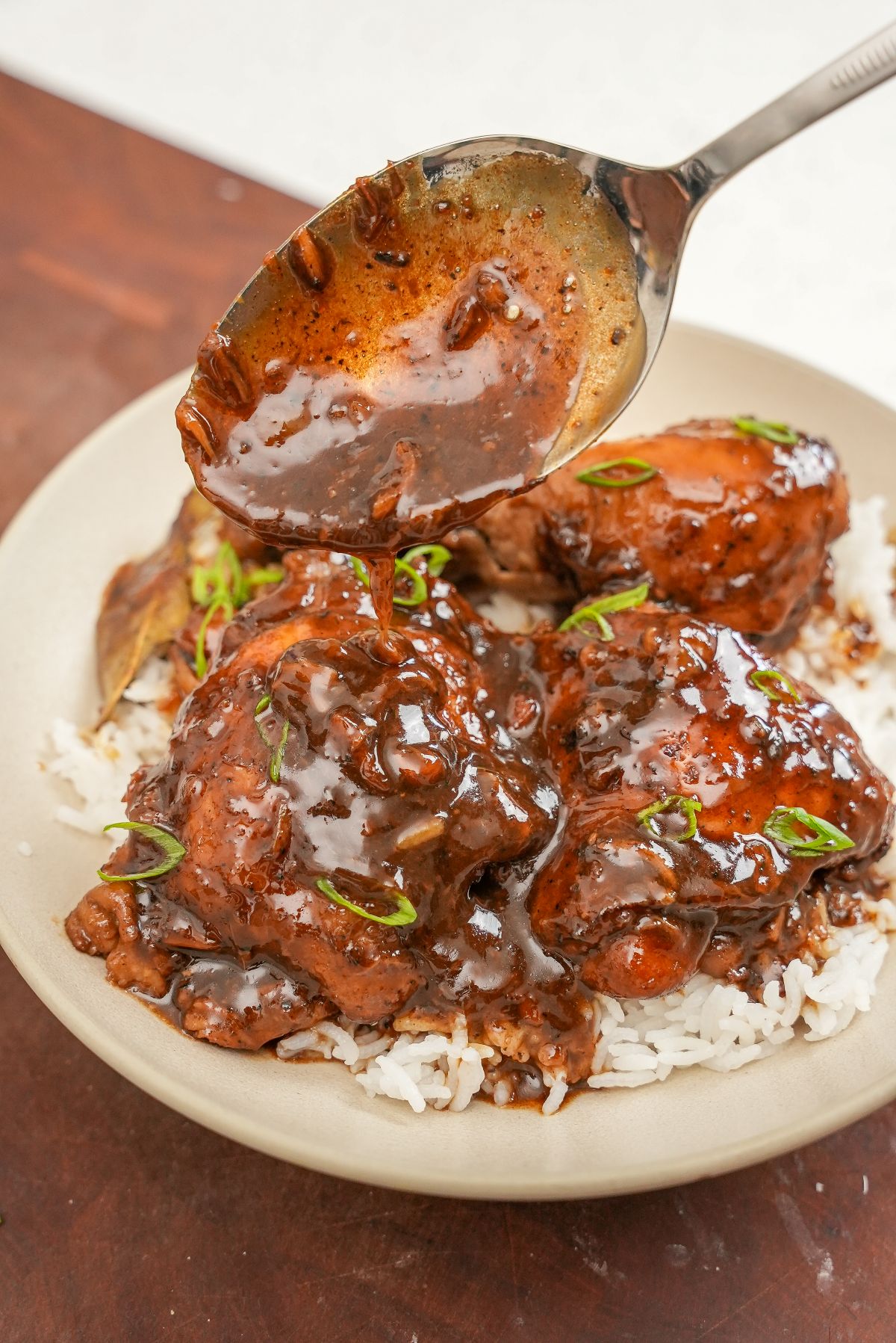 Chicken Adobo over rice in a bowl.