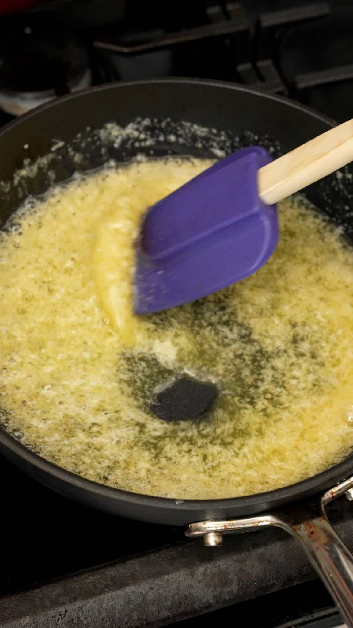 Garlic butter cooking in a pan made from butter, garlic powder, grated garlic, and salt.