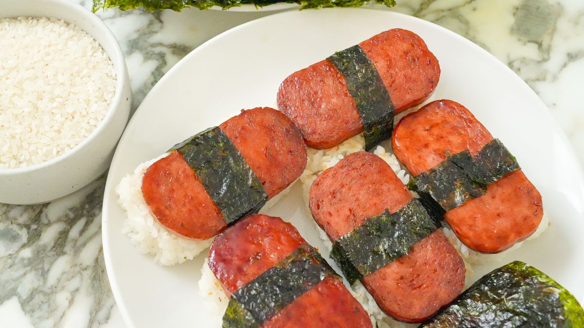 Spam Musubi on a plate with a bowl of rice.