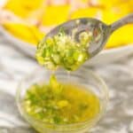 Ginger Scallion Sauce in a glass bowl with a spoon.