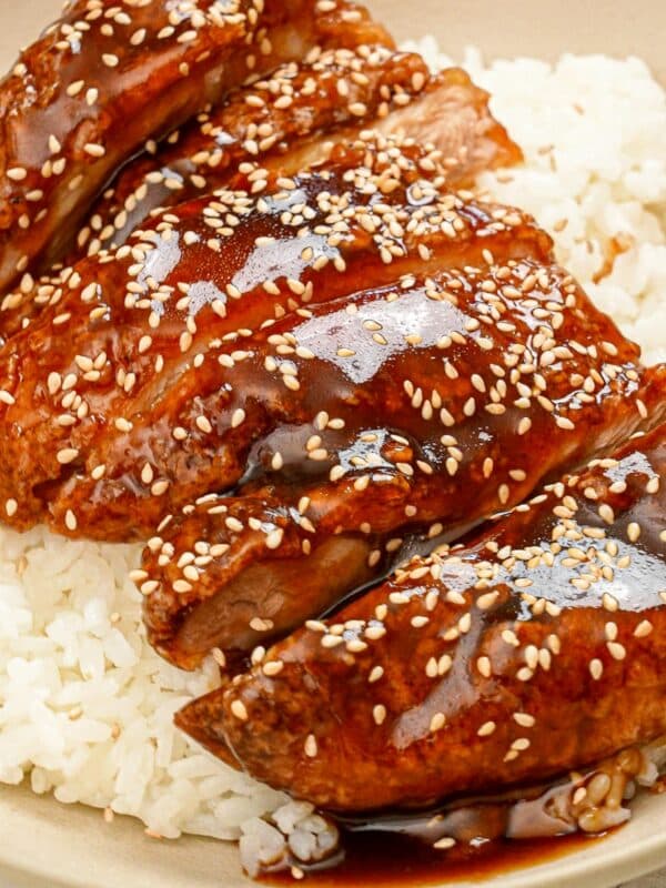 Honey Butter Chicken on a bed of rice in a bowl.