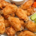 Air Fryer Chicken Wings on a plate with carrots and celery with ranch dressing.