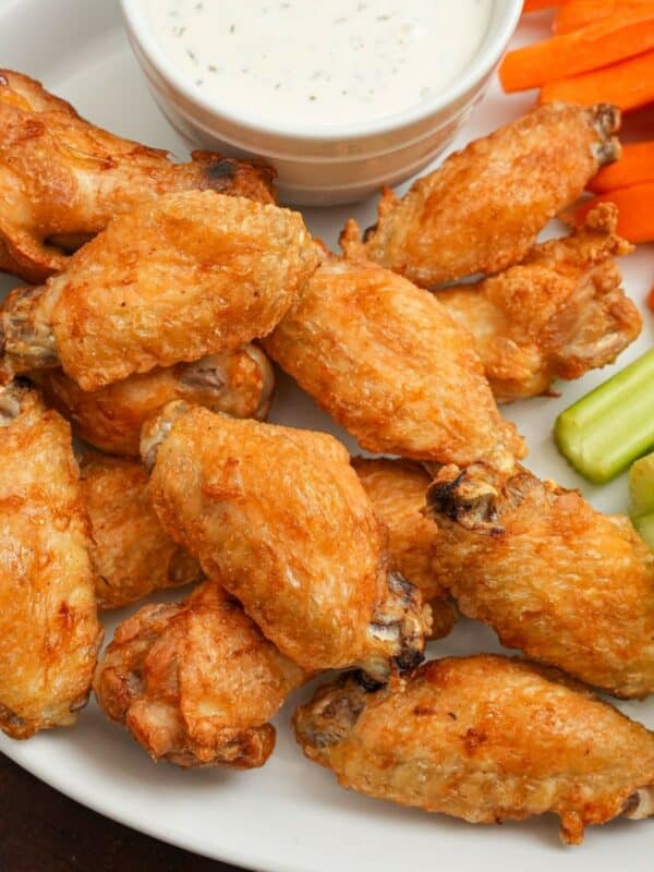 Air Fryer Chicken Wings on a plate with carrots and celery with ranch dressing.