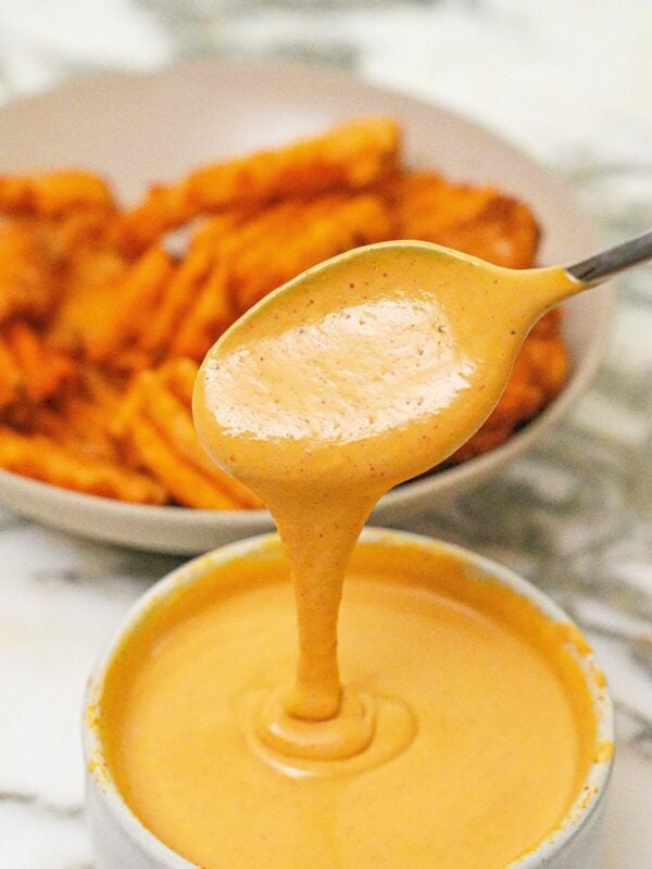 Copycat Chick-fil-a-sauce in a bowl next to a bowl of fries.