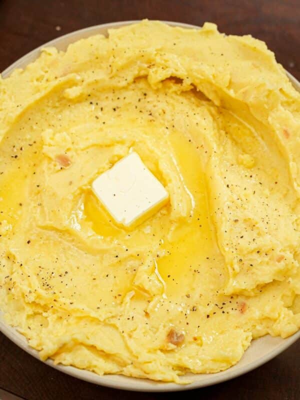 A bowl of garlic mashed potatoes with butter.