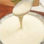 Copycat Wingstop ranch in a metal bowl in front of a wingstop paper bag.