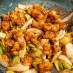 Black Pepper Tofu fried and cooked in a blue carbon steel wok.