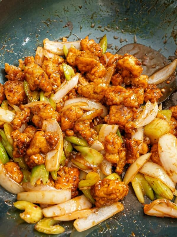 Black Pepper Tofu fried and cooked in a blue carbon steel wok.