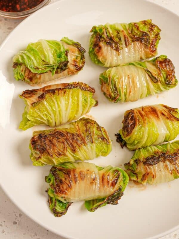 Steamed Asian cabbage rolls on a plate.