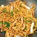 Din Tai Fried Noodles with Chicken cooked in a wok.