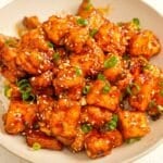 Crispy General Tso's Tofu in a bowl over rice.