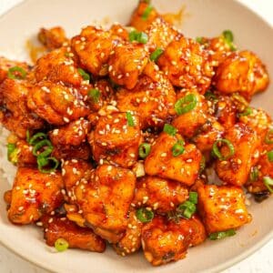 Crispy General Tso's Tofu in a bowl over rice.