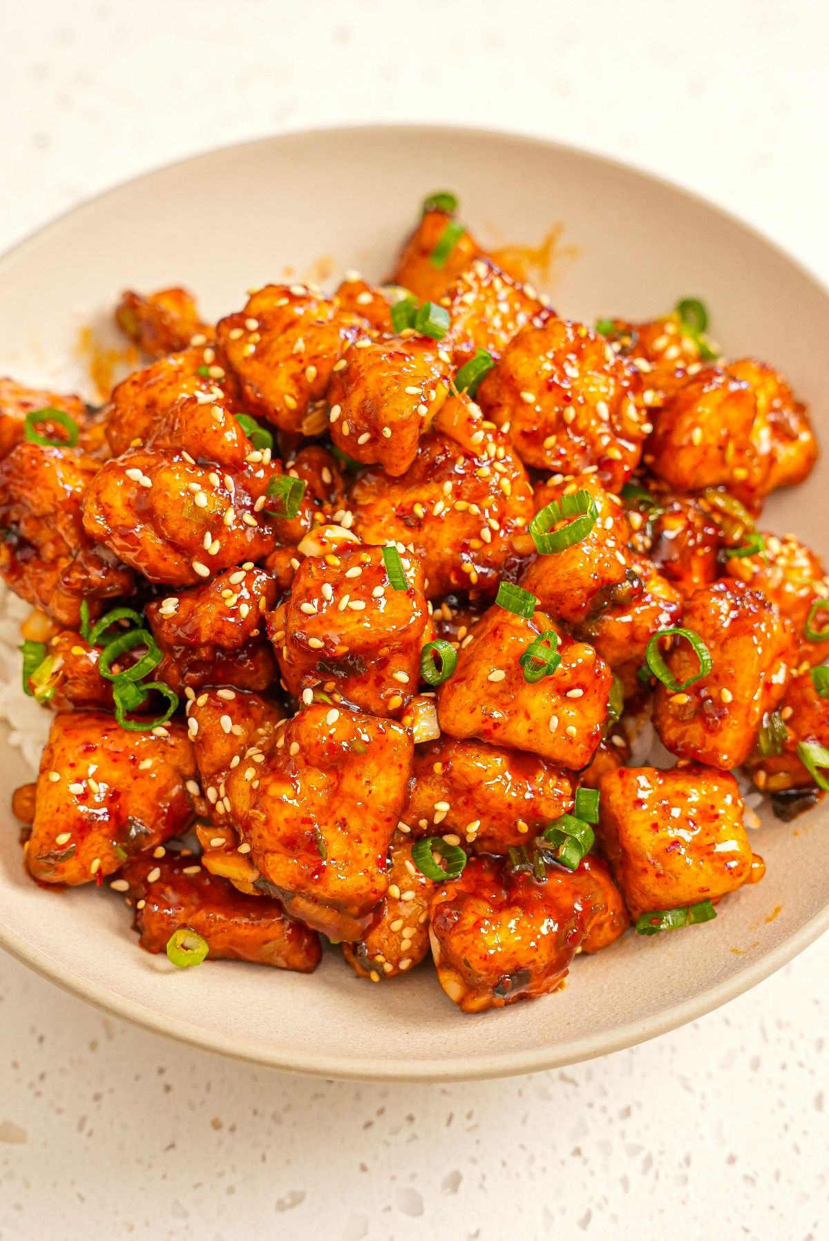 Crispy General Tso's Tofu in a bowl over rice.
